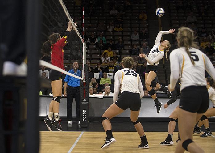 Iowas no. 8 Reghan Coyle jumps to return the ball during a volleyball match at Carver Hawkeye Arena in Iowa City on Wednesday, Sept. 28 , 2016. Iowa defeated Maryland 3-0. (The Daily Iowan/Ting Xuan Tan)