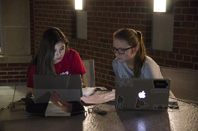 Ashley Martinez and Andra McCrery, both UI freshman, study at the Iowa Memorial Union River Terrace on the evening of Tuesday, Oct. 11, 2016. The terrace hosts various events and overlooks the Iowa River. (The Daily Iowan/Olivia Sun)