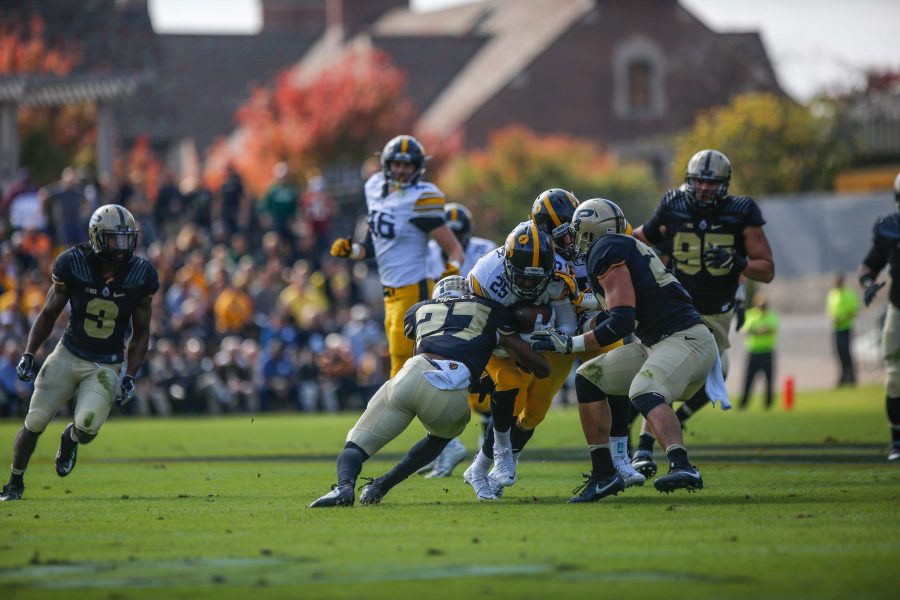 Iowa running back Akrum Wadley fights through the Purdue defensive during the Iowa v. Purdue football game at RossÐAde Stadium on Saturday, Oct. 15, 2016. The Iowa Hawkeyes lead the Purdue Boilermakers 35-7  at the half. (The Daily Iowan/Anthony Vazquez)