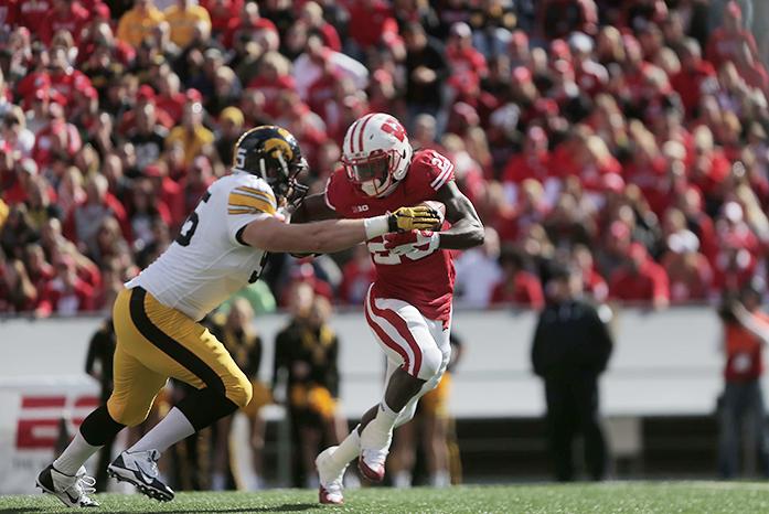 Iowa defensive lineman Drew Ott attempts to tackle Wisconsin running back Dare Ogunbowale during the Iowa-Wisconsin game in Camp Randal Stadium on Saturday, Oct. 3, 2014. The Hawkeyes defeated the Badgers, 10-6. (The Daily Iowan/Margaret Kispert)