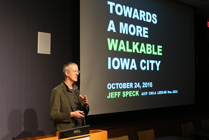 City planner and urban designer Jeff Speck talks about walkable and sustainable cities in the Iowa City Public Library on Monday. Speck described ways in which Iowa City could become more sustainable. (The Daily Iowan/Osama Khalid)
