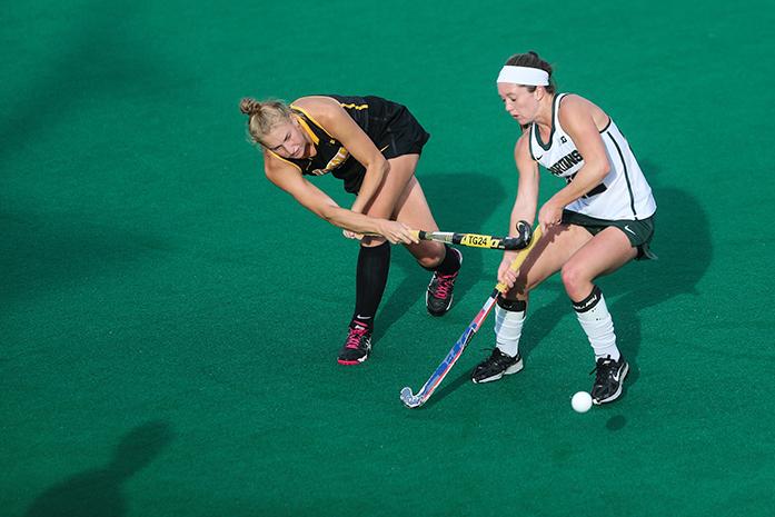 Iowa defender Chandler Ackers tries to pass off the ball during the Iowa v. Michigan State field hockey match at Grant Field on Friday, Oct. 21, 2016. The Hawkeyes defeated the Spartans 5-3. (The Daily Iowan/Anthony Vazquez)