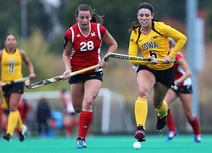 Iowa forward Mallory Lefkowitz and Miami back Ali Froede go after the ball at Grant Field on Sunday, Oct. 12, 2014.(The Daily Iowan/John Theulen)