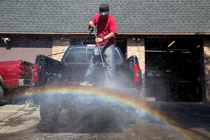 David Guerrero washes the bed of a truck as part of a makeshift car detailing service offered to car dealership in Burnsville, Minnesota. A number illegal immigrants take odd jobs to maintain an income and avoid the question of documentation and legal status that often comes up with larger factory jobs. While it doesn't pay as much, and there are no benefits to the job, these small jobs have become a necessity to keep food on the table and most importantly to keep their dreams alive. (The Daily Iowan/Anthony Vazquez)