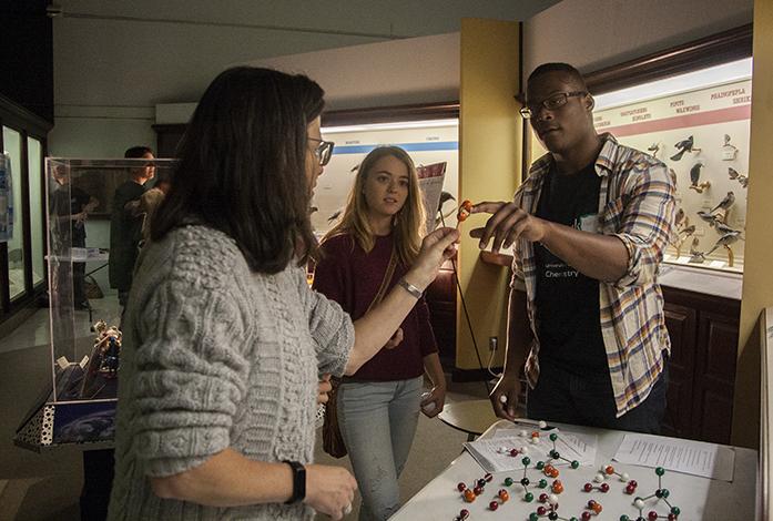 An attendee asks about a molecular formation during the Iowa Climate Festival at the Museum of Natural History in Iowa City on Saturday, Oct 15, 2016. There were hands-on experiments at the Climate Science Fair for attendees to interact and learn with. (The Daily Iowan/Ting Xuan Tan)