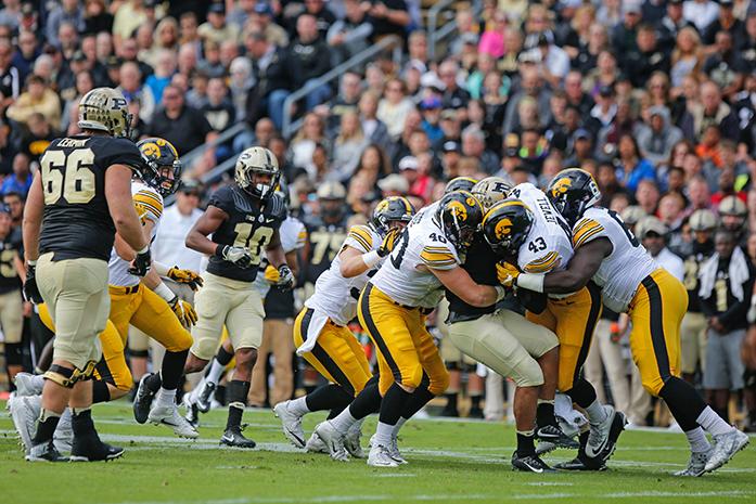 The defensive line wraps up the Purdue running back during the Iowa v. Purdue football game at Ross–Ade Stadium on Saturday, Oct. 15, 2016. The Iowa Hawkeyes beat the Purdue Boilermakers 49-35. (The Daily Iowan/Anthony Vazquez)