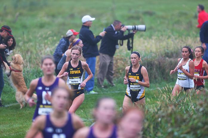 Iowa runners Claire Dupus and Julie Hollensbe round the corner with a good stride. Tess Wilberding placed 2nd for the Hawkeyes in the Women's 6k. (The Daily Iowan/Karley Finkel)