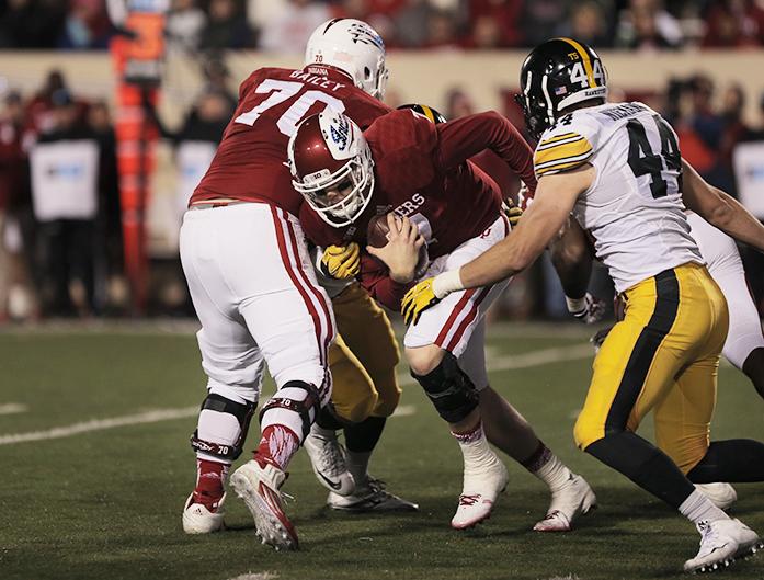 Indiana quarterback Nate Sudfeld tries to avoid a tackle by Iowa linebacker Ben Niemann during the Iowa-Indiana game in Memorial Stadium in Bloomington on Saturday, Nov. 7, 2015. The Hawkeyes stay undefeated after beating the Hoosiers, 35-27. (The Daily Iowan/Rachael Westergard)