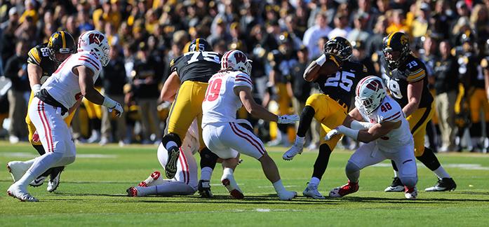 Iowa running back Akrum Wadley attempts to spin his way through a tackle from Wisconsin line backer Jack Cichy during the Iowa v. Wisconsin game at Kinnick Stadium on Saturday, October 22, 2016. The Badgers pulled away in the second half defeating the Hawkeyes 17-9. (The Daily Iowan/ Alex Kroeze)