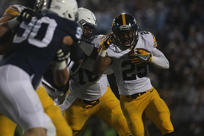 Iowa running back Akrum Wadley attempts to avoid Penn State defenders during the Iowa-Penn State game in Beaver Stadium in College State on Saturday, Nov. 5, 2016. The Nittany Lions defeated the Hawkeyes, 41-14. (The Daily Iowan/Margaret Kispert)