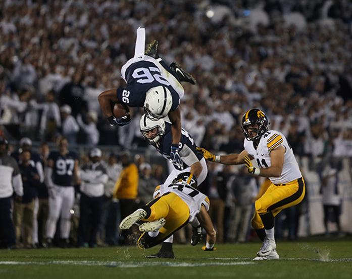 Penn State running back Saquon Barkley attempted to hurdle of Iowa defensive back Brandon Synder during the Iowa-Penn State game in Beaver Stadium in College State on Saturday, Nov. 5, 2016. The Nittany Lions defeated the Hawkeyes, 41-14. (The Daily Iowan/Margaret Kispert)