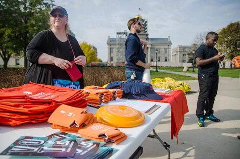 NextGen Climate volunteers hand out merchandise and help students register to vote on Monday, November 7, 2016. NextGen aims to prevent climate disaster through advocating political involvement on campus. (The Daily Iowan/Olivia Sun)