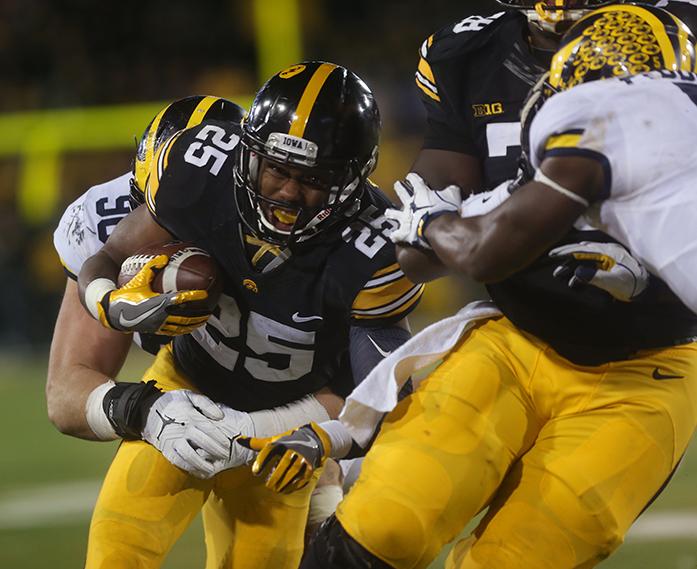 Iowa+running+back+Akrum+Wadley+is+tackled+by+Michigan+defensive+tighten+Bryan+Mone+during+the+Iowa-Michigan+game+at+Kinnick+on+Saturday%2C+Nov.+12%2C+2016.+The+Hawkeyes+defeated+No.+2+Michigan+by+a+33-yard+field+goal+with+no+time+left+to+win%2C+14-13.+%28The+Daily+Iowan%2FMargaret+Kispert%29