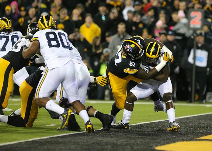 Iowa defensive lineman Jaleel Johnson gets a safety on Michigan running back DeVeon Smith during the game between Michigan and Iowa at Kinnick Stadium on Saturday, November 12, 2016. Iowa kicker Keith Duncan nailed a 33 yard field goal as the time ran out to beat the No. 2 Wolverines 14-13. (The Daily Iowan/ Alex Kroeze)