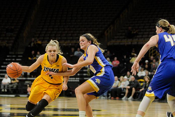 Iowa guard Ally Disterhoft drives past South Dakota State guard Kerri Young during a basketball game in Carver-Hawkeye Arena on Sunday, Nov. 20, 2016. The Jackrabbits defeated the Hawkeyes, 66-64, in Iowa City. (The Daily Iowan/Osama Khalid)