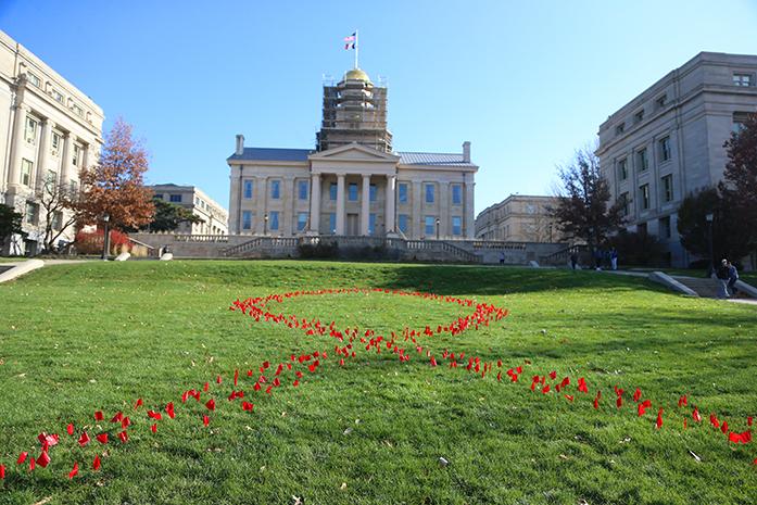 Red+flags+are+placed+in+the+center+of+the+lawn+in+front+of+the+Old+Capitol+on+Tuesday%2C+November+29%2C+2016.+The+red+ribbon+is+a+symbol+for+awareness+with+illegal+drugs%2C+drunk+driving%2C+stopping+illegal+drugs%2C+and+people+living+with+HIV%2FAIDS.+%28The+Daily+Iowan%2F+Alex+Kroeze%29