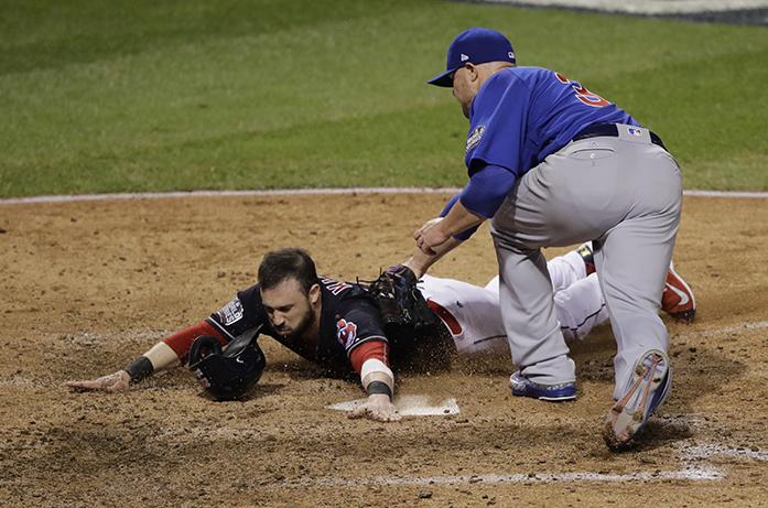 Cleveland Indians Jason Kipnis scores past Chicago Cubs Jon Lester during the fifth inning of Game 7 of the Major League Baseball World Series Wednesday, Nov. 2, 2016, in Cleveland. (AP Photo/Gene J. Puskar)