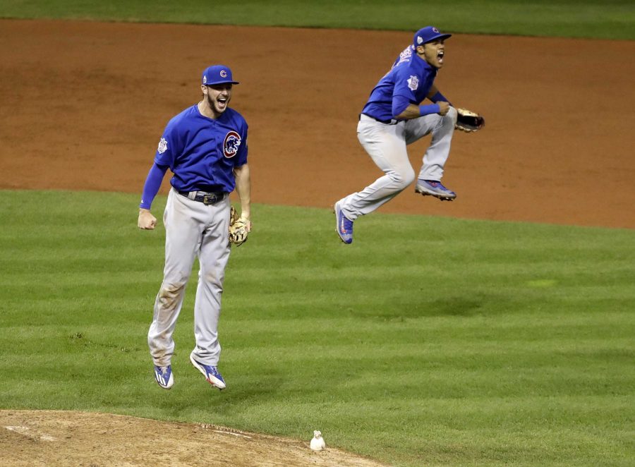 Chicago Cubs Kris Bryant, left, and Addison Russell celebrate after Game 7 of the Major League Baseball World Series against the Cleveland Indians Thursday, Nov. 3, 2016, in Cleveland. The Cubs won 8-7 in 10 innings to win the series 4-3. (AP Photo/David J. Phillip)