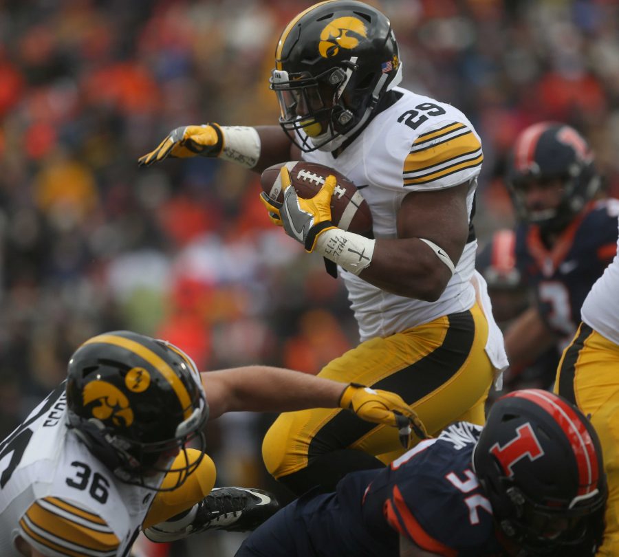 Iowa running back LeShun Daniels, Jr. jumps over Illinois linebacker Justice Williams during the Iowa-Illinois game in Memorial Stadium in Champaign on Saturday, Nov. 19, 2016. The Hawkeyes defeated the Fighting Illini, 28-0. (The Daily Iowan/Margaret Kispert)