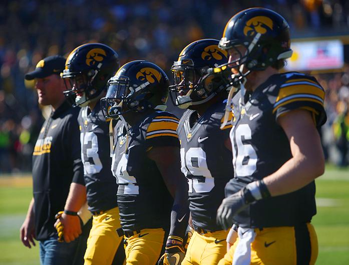 Iowa captians Josey Jewell, Desmond King, LeShun Daniels Jr. and C.J. Beathard walk to the coin toss at the beginning of the Iowa-Wisconsin game at Kinnick on Saturday, Oct. 22, 2016. The Hawkeyes were defeated by the Badgers, 19-7. (The Daily Iowan/Margaret Kispert)