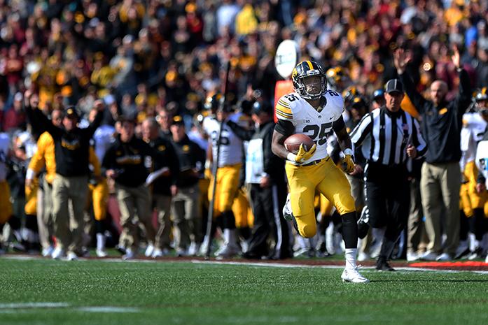 Iowa running back Akrum Wadley runs in for 54-yard touchdown during the Iowa-Minnesota game at TCF Banks Stadium in Minneapolis on Saturday, Oct. 8, 2016. The Hawkeyes defeated the Golden Gophers, 14-7. (The Daily Iowan/Margaret Kispert)