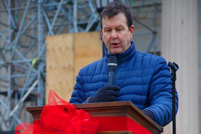 Jack Stapleton reads names of those lost to AIDS in front of the Capital Building at the University of Iowa on December 1, 2016. Stapleton has worked at the UI AIDS clinic since 1986. (The Daily Iowan/Karley Finkel)