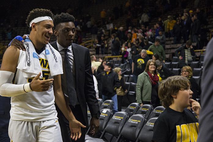Iowa forward Cordell Pemsl walks off the court with Iowa forward Tyler Cook after a basketball game in Carver-Hawkeye Arena on Monday, Dec. 5, 2016. The Hawkeyes defeated the Hatters, 95-68, where Cook was sidelined due to a finger fracture. (The Daily Iowan/Joseph Cress)