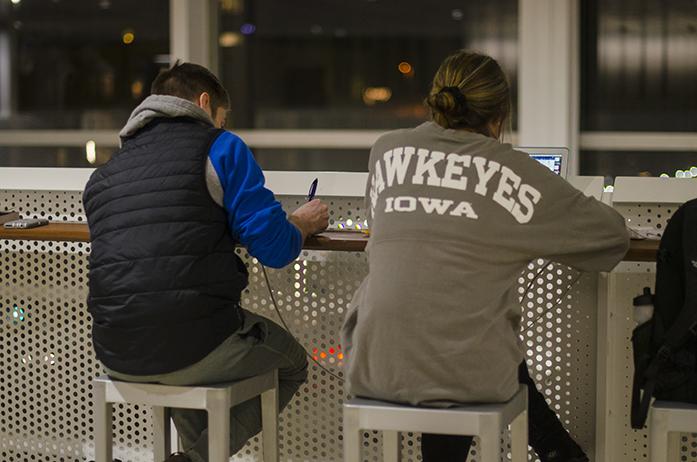 UI sophomores Brittney Durian and Lucas Kelly study on the third-floor balcony of Voxman Music Building on Wednesday, Dec. 7, 2016. (The Daily Iowan/Olivia Sun)