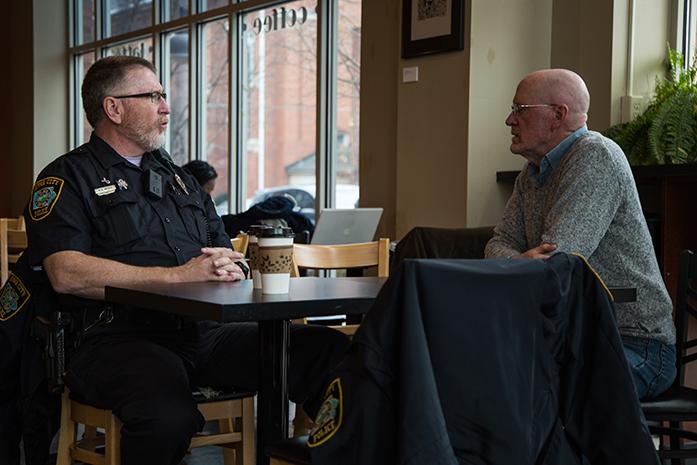 Officer R.A. Mebus sits down with City Council Member Jim Throgmorton, Council Member Throgmorton was working at High Ground and decided to take a break to speak to the officer, Coffee with a Cop is part of a monthly program that allows citizens sit down with police officers in an informal setting and ask questions or have a simple discussion. Coffee with a cop took place at High Grounds in Iowa City, Iowa on Nov. 30.(The Daily Iowan/Anthony Vazquez)