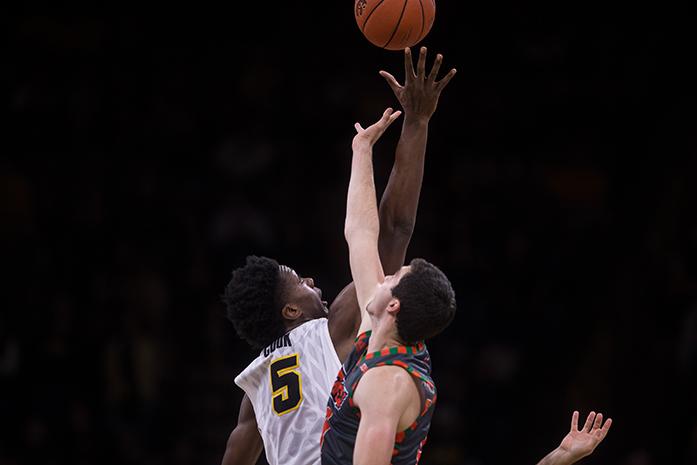 Iowa forward Tyler Cook tries to get control of the ball at the jump off during the Iowa v. Texas Rio Grande Valley basketball game at the Carver-Hawkeye Arena, in Iowa City, Iowa  on Sunday, Nov. 20, 2016. The Hawkeyes beat the Vaqueros 95-67.(The Daily Iowan/Anthony Vazquez)