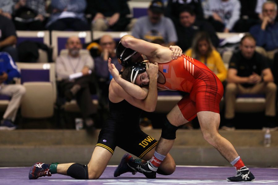 Iowa 157-pounder Michael Kemerer wrestles unattached wrestler Jason Tsirtis during the 54th Annual Ken Kraft Midlands Championships in Welsh-Ryan Arena on Friday, Dec. 30, 2016 in Evanston, Il. Kemerer defeated Tsirtis by major decision, 11-2. (The Daily Iowan/Joshua Housing)
