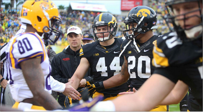 Iowa and LSU captains shake hands before the Outback Bowl in Tampa, Florida, on Jan. 1, 2014. The Hawkeyes fell, 21-14. (The Daily Iowan/File Photo)