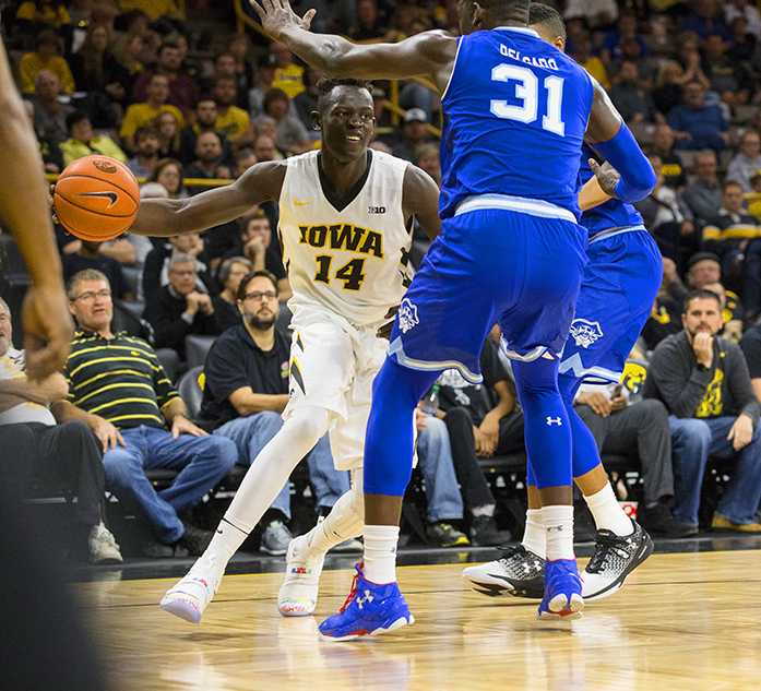Iowa guard Peter Jok dribbles past Seton Hall forward Angel Delgado during a basketball game in Carver-Hawkeye Arena on Thursday, Nov. 17, 2016. The Pirates defeated the Hawkeyes, 91-83, in Iowa City. (The Daily Iowan/Joseph Cress)
