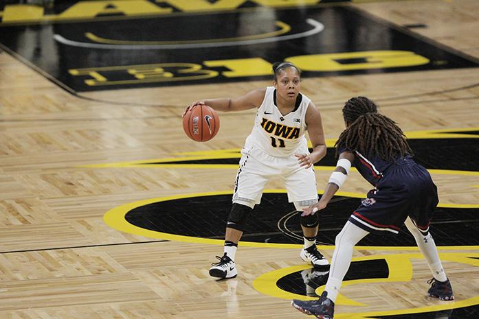 Iowa guard Tania Davis dribbles the ball against a defender at mid-court during the Iowa-Robert Morris game in Carver-Hawkeye Arena on Friday, Dec. 9, 2016. The Hawkeyes defeated the Colonials, 81-60. (The Daily Iowan/Margaret Kispert)