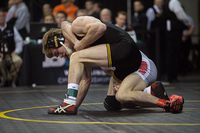 Iowa's 149-pounder Brandon Sorenson holds off Ohio State's Cody Burcher during the first round of the Big Ten Championships at Carver-Hawkeye Arena on Saturday, March 5, 2016. This year marks the 102nd annual Big Ten Wrestling Championship since its inception in 1913. (The Daily Iowan/Anthony Vazquez)