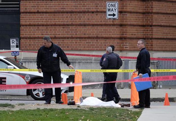 FILE - In this Monday, Nov. 28, 2016 file photo, police cover the body of a suspect outside Watts Hall on the campus of Ohio State University in Columbus, Ohio, following an attack on campus that left several people injured. The man, identified as Abdul Razak Ali Artan, plowed his car into a group of pedestrians and began stabbing people with a butcher knife Monday before he was shot to death by a police officer. Leaders of the mosque say they dont remember Artan, and Ohio States Muslim and Somali student groups say he wasnt affiliated with their organizations. (Adam Cairns/The Columbus Dispatch via AP, File)