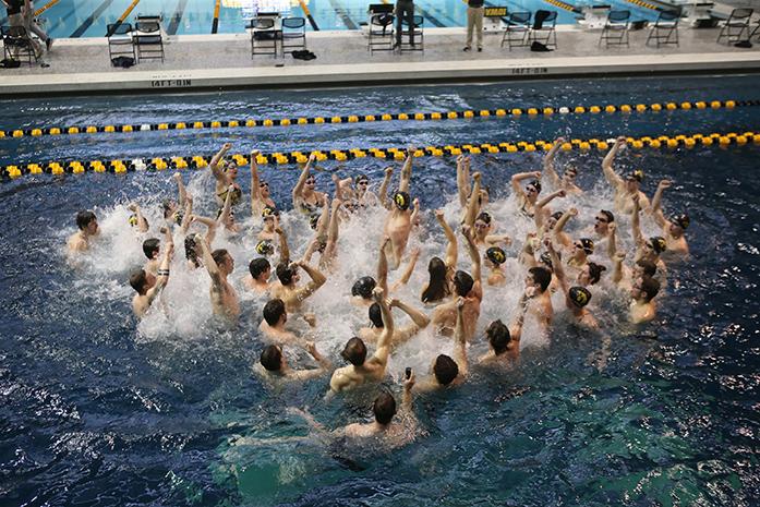 The Iowa team celebrates winning after the Iowa-Northwestern meet at the Campus Recreation and Wellness Center on Saturday, Jan. 21, 2017. The Hawkeyes defeated the Wildcats, 156-144. (The Daily Iowan/Margaret Kispert)