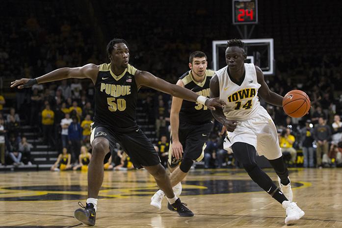 Iowa guard Peter Jok dribbles past Purdue forward Caleb Swanigan during a mens basketball game in Carver-Hawkeye Arena between Iowa and Purdue on Thursday, Jan. 12, 2017. The Hawkeyes defeated the Boilermakers, 83-78. (The Daily Iowan/Joseph Cress)