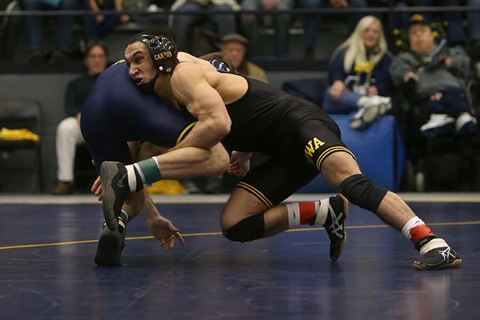 Iowa 141-pounder Topher Carton dives at Michigans Sal Profaci during the Iowa-Michigan meet at Cliff Keen Arena in Ann Arbor on Friday, Jan. 6, 2017. Carton defeated Profaci with a 8-4 decision. The Hawkeyes defeated the Wolverines, 31-7. (The Daily Iowan/Margaret Kispert)