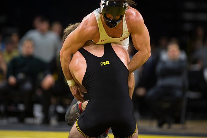 Ohio States Josh Fox grapples with Iowas Steven Holloway during the Iowa v. Ohio State Wrestling match, in Carver-Hawkeye Arena in Iowa City, Iowa  on Friday, Jan. 27, 2017. The Hawkeyes beat the Buckeyes with a team score of 21-13. (The Daily Iowan/Anthony Vazquez)