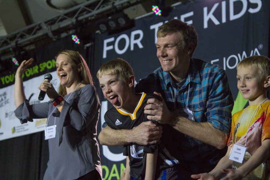 The Lee family gives their testimony to dancers during hour five of the Dance Marathon 23 at the Iowa Memorial Union on Friday, Feb. 3, 2017. The youngest son, Caleb, needed a bone marrow transplant and his  his older brother was a perfect match. (The Daily Iowan/Margaret Kispert)