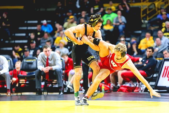 Iowas Thomas Gilman tires to takedwon Wisconsins Jens Lantz during the Iowa v. Wisconsin wrestling bout, in Carver-Hawkeye  in Iowa City, Iowa  on Friday, Feb. 3, 2017. The Hawkeyes defeated the Badgers with a team overall of 33-8. (The Daily Iowan/Anthony Vazquez)