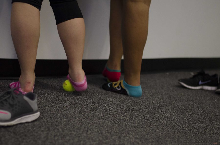 A dancer rolls a ball on her feet in the texture room during the hour 19 during the 23 Dance Marathon at the Iowa Memorial Union on Saturday, Feb. 4, 2017. (The Daily Iowan/Karley Finkel)