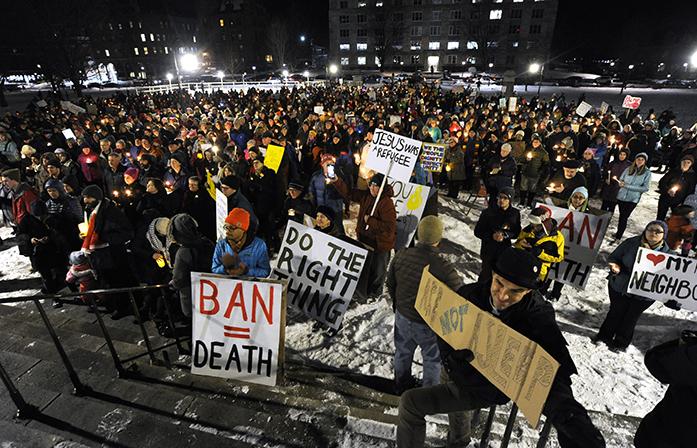 A crowd gathers on the State House lawn in Montpelier, Vt., Wednesday, Feb. 1, 2017, for a solidarity candlelight vigil in response to President Donald Trumps recent travel ban on refugees and citizens of certain majority-Muslim countries. (Jeb Wallace-Brodeur/The Times Argus via AP)