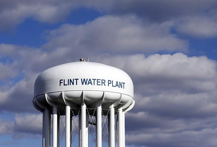 FILE - In this March 21, 2016 file photo, the Flint Water Plant water tower is seen in Flint, Mich. Michigan environmental officials announced Tuesday, Jan. 24, 2017, that Flints water system no longer has levels of lead exceeding the federal limit. The finding by the Department of Environmental Quality is good news for a city whose 100,000 residents have grappled with the man-made water crisis since 2014. (AP Photo/Carlos Osorio, File)