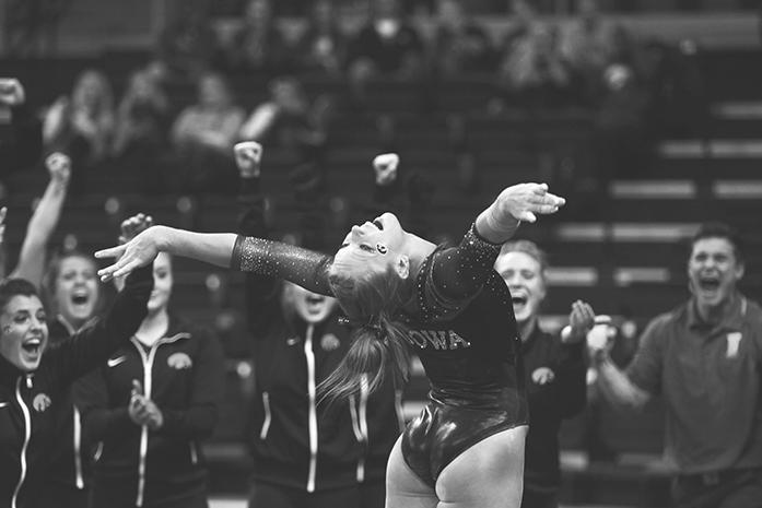 Junior Mollie Drenth celebrates alongside teammates after landing a move off of the beam Monday January 18th, 2016 at Carver Hawkeye Arena. The Hawkeyes faced off against the University of Denver in Iowa City on Monday. (The Daily Iowan/Kyle Close)