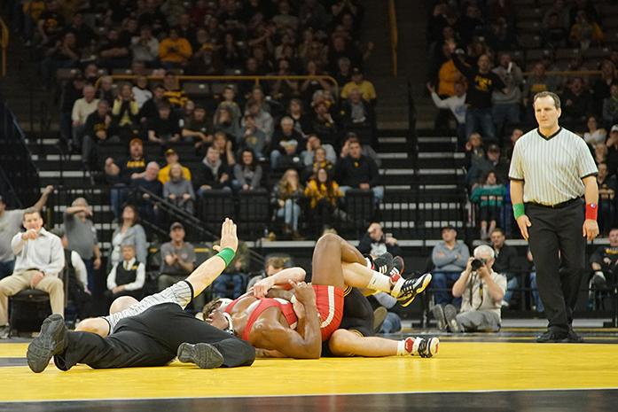 Iowa 184 pound Sammy Brooks drags Nebraskas Jaquan Sowell to the center of the ring during the Iowa-Nebraska match in Carver-Hawkeye Arena on Sunday, Feb 12, 2017. Brooks pinned Nebraskas Sowell at 1:59.6 into the match. The Hawkeyes defeated the Cornhuskers, 27-9. (The Daily Iowan/James Year)