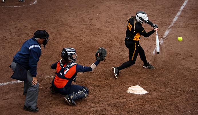 Iowa's Brooke Rozier swings at the ball during the first game of the Iowa-Illinois match up on March 26, 2017. Illinois defeated Iowa 5-2 to win the first game. (The Daily Iowan/Osama Khalid)