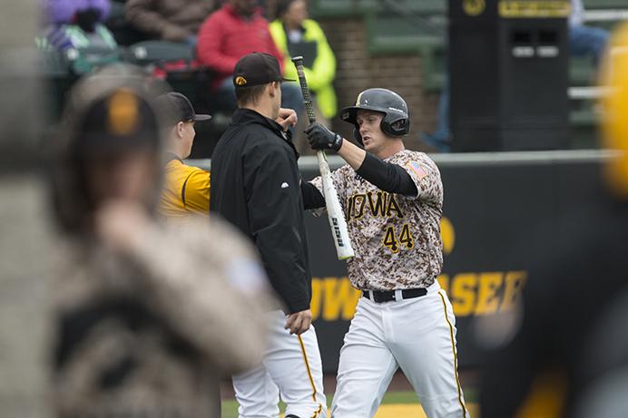 Iowa outfielder Robert Neustrom bumps fists with teammates after getting a run during a baseball game with Grand View at Duane Banks Field on Tuesday, March 28, 2017. The Hawkeyes defeated the Vikings, 6-5. (The Daily Iowan/Joseph Cress)