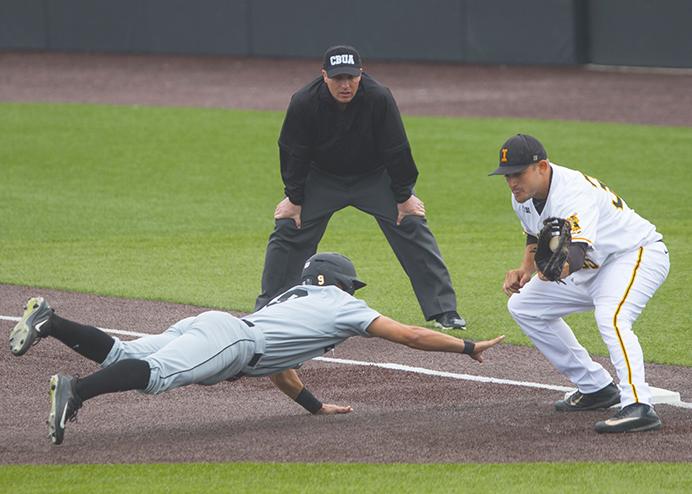 Purdue+catcher+Nick+Dalesandro+dives+towards+first+safe+ahead+of+the+tag+by+Iowa+first+basemen+Jake+Adams+during+a+baseball+game+at+Duane+Banks+Field+on+Friday%2C+March+24%2C+2017.+The+Boilermakers+defeated+the+Hawkeyes%2C+2-0%2C+on+two+runs+during+the+eighth+inning+following+a+one+hour+rain+delay.+%28The+Daily+Iowan%2FJoseph+Cress%29